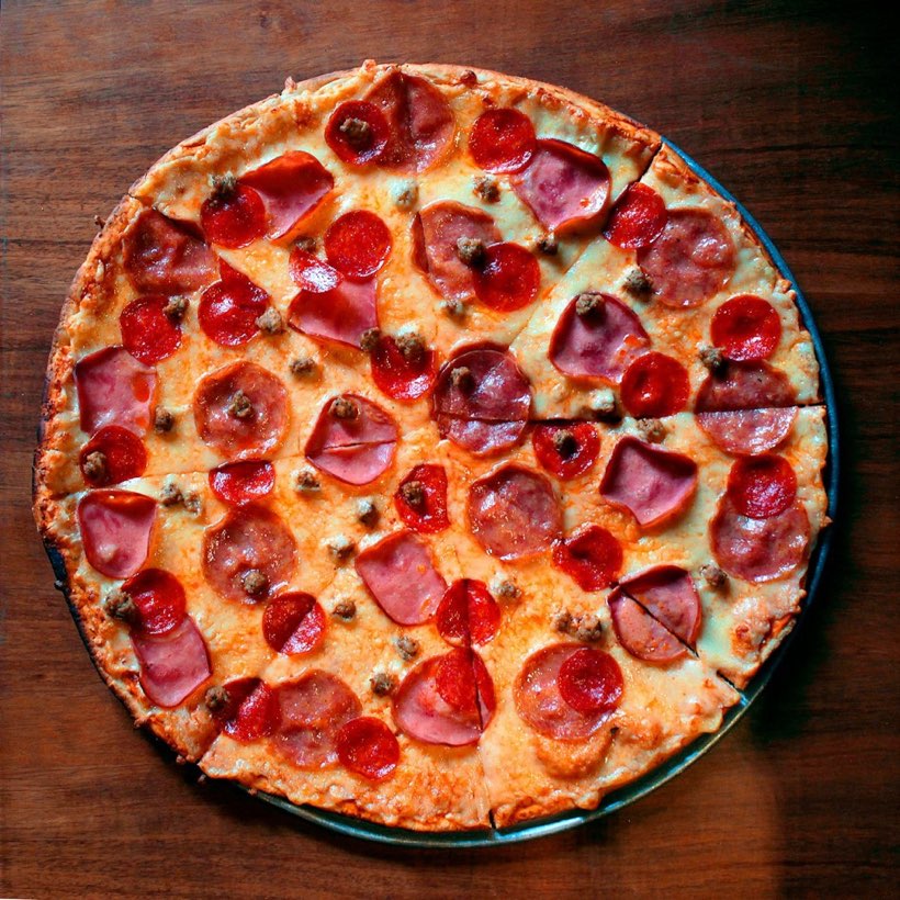 Super Supreme loaded pizza with pepperoni, ham, sausage, and vegetables at Fat Duck's Pizza Sacramento