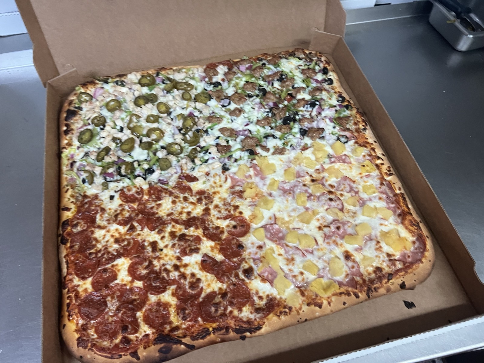 Giant square Team pizza split four ways with pepperoni, chicken jalapeno, Hawaiian, and combination at Fat Duck's Pizza in South Sacramento