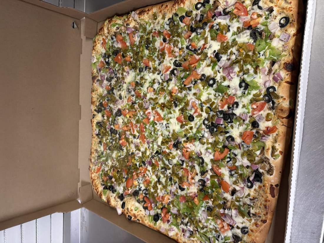 Giant vegetarian Team pizza loaded with olives, tomatoes, peppers, and onions at Fat Duck's Pizza Sacramento